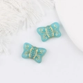 Macro detail of sky blue butterfly Czech glass beads with gold gilded textures for DIY jewelry - Lake Blue
