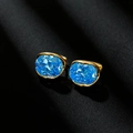 Elegant gold earrings with sparkling oval blue zircon crystals on a black background - 18K Gold Plated Sky Blue Zircon