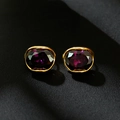 Elegant gold earrings featuring deep purple oval-cut gemstones on dark silk background - 18K Gold / Purple Zirconia