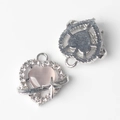 Macro detail of heart-shaped pink opal pendant with silver star and sparkling crystals - Silver Base Purple
