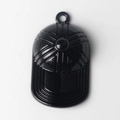 Macro shot of black baseball cap pendant with embossed sunburst texture and top loop - Black