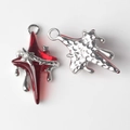 Detailed macro view of star-shaped cross charms with red resin and silver metal drips - Silver Base Red
