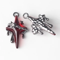 Macro shot of dark silver star pendants with red resin inlay and crystal accents - Gunmetal Red