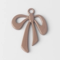 Close-up of matte dusty pink bow pendant charm with top ring for DIY jewelry making - Brown