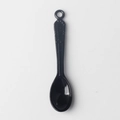 Detailed view of a vintage black spoon pendant with engraved patterns and top ring loop - Black