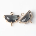 Detailed view of half-moon dark gray faceted stone pendants with three gold-plated loops - Black