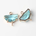 Close-up of fan-shaped natural stone pendants with gold-plated bezel and triple loops - Lake Blue