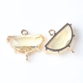 Macro shot of faceted semi-circular natural stone connector with gold plated brass edge - Pale Yellow