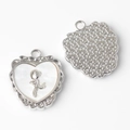 Detail of silver alloy heart pendant with rose relief and star texture on the back - Silver White