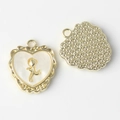 Close-up of heart resin pendant with gold rose and starry textured back for DIY jewelry - Gold White