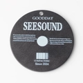 Macro shot of circular acrylic CD charm with matte black finish and white retro lettering - Black