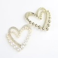 Detailed view of heart-shaped DIY jewelry charms with pearls and sparkling rhinestones - Gold