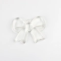 Close-up of transparent resin bow pendant with top hole for DIY jewelry making - 41*31mm / Transparent Large Bow