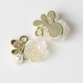 Detailed view of DIY jewelry charms with resin camellia flower and golden butterfly - Gold Base White
