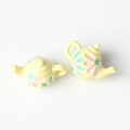 Detailed top view of two yellow teapot pendants with colorful floral painted patterns - Yellow