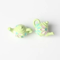 Close-up of mini light green floral teapot pendants for DIY jewelry making and crafts - Green