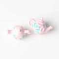 Detailed view of pink resin teapot charms with floral patterns for DIY jewelry making - Pink