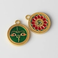 Detailed macro of colorful alloy evil eye and mandala charms with gold metal edges - Green