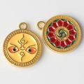 Detail of colorful alloy evil eye charms with red green geometric patterns and gold plating - Yellow