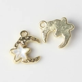 Macro detail of alloy star and moon pendant showing textured front and matte back - Gold White