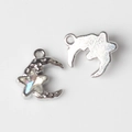Macro shot of silver crescent moon and star pendant charms for DIY jewelry making - Silver White