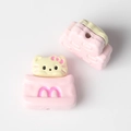 Macro view of Hello Kitty style cat bead with pink M logo for DIY jewelry making - Pink