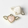 Macro detail of winged heart pendant showing glitter resin front and textured gold back - Gold Pink