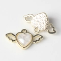 Detailed view of heart wing pendant with pearlescent resin inlay and golden alloy base - Gold White