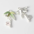 Detailed close-up of alloy bamboo leaves and pink flower charms for DIY jewelry making - Green Gradient Bamboo Leaf with Pink Flower / Silver