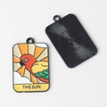 Detail of colorful parrot sun tarot charm with red and yellow enamel and textured back - The Sun