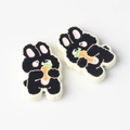 Detailed view of two cute black rabbit charms with orange carrots for DIY jewelry - Black with White Edge