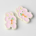 Close-up of pink bunny alloy pendants with orange carrot for DIY jewelry making - White to Pink