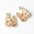 Macro detail of Japanese style fox mask alloy pendants with pink and red enamel glaze - Pink with Gold Edge