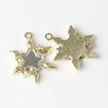 Macro detail of star pendant with mirror finish and sparkling rhinestones inlay - Gold Base White
