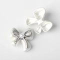 Detailed front and back views of white resin bow charms with imitation pearl and silver trim - White Silver