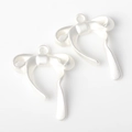 Detailed view of matte silver bow pendants with asymmetrical tassels for DIY jewelry - Silver White