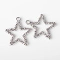 Close-up of silver alloy star charms with hammered texture for DIY jewelry making - Silver