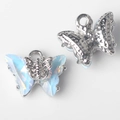 Macro shot of silver butterfly pendants with iridescent blue crystals for jewelry making - Silver Base Blue