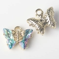 Macro detail of butterfly jewelry pendant showing crystal facet and gold textured back - Gold Base Green