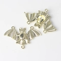 Detailed view of golden bat-shaped alloy connectors with three loops for DIY jewelry - Gold