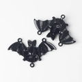 Close-up of black alloy bat connector charms with 3 loops for DIY jewelry making - Black