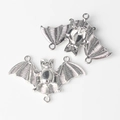 Detailed view of alloy bat connector pendants with wings and polished silver finish - Silver