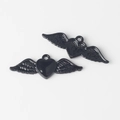 Macro detail of black winged heart pendants with glossy finish for DIY jewelry making - Black base Black