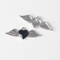 Detailed view of alloy heart charms with black wings and star embossed texture on reverse - Silver Base Black