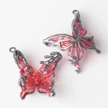 Detailed close-up of pink resin butterfly charms with dark gunmetal frames for DIY jewelry - Large / Gun Black Red Stone