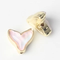 Macro shot of two golden fish tail charms with pink resin inlay for DIY jewelry projects - Gold Base Pink