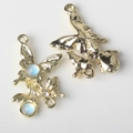 Detailed macro shot of gold-plated butterfly resin charms with blue moonstone and zircon - Gold Base Blue