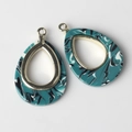 Detailed macro view of teardrop marble resin pendant with gold metal frame for DIY jewelry - Green