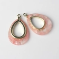 Detail of pink marble resin teardrop pendants with gold metal frames for DIY jewelry - Pink