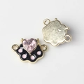 Detailed view of alloy cat paw jewelry connector with pink crystal and black enamel - Gold